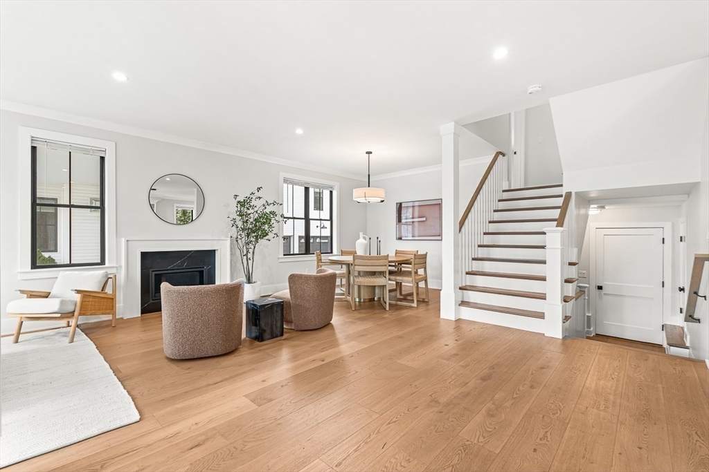 65 Summer Street, Unit 1 Natick, MA 01760 - Photo 10 of 21 a living room with furniture a fireplace and wooden floor