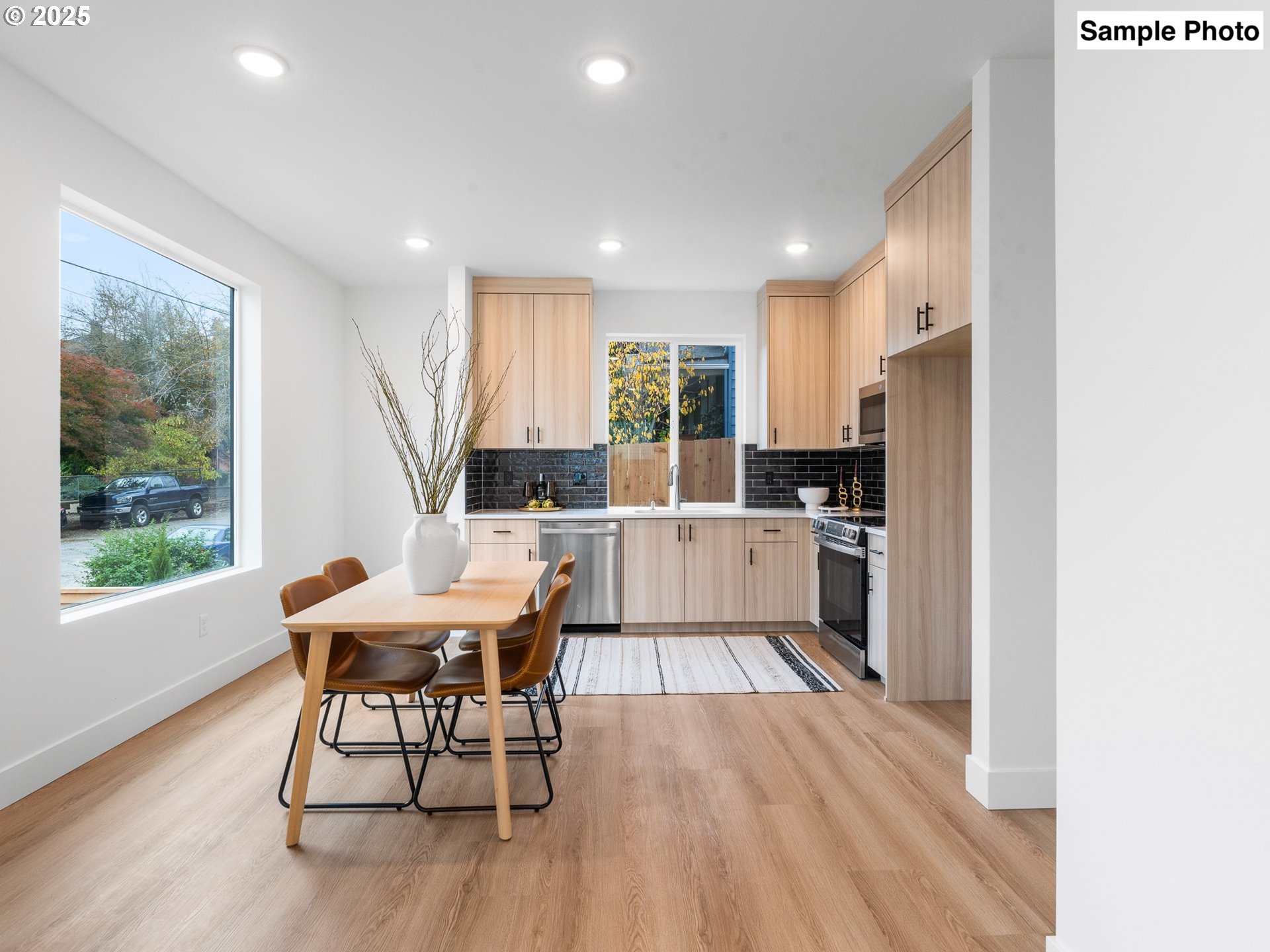 3554 North Haight Avenue, Unit 3 Portland, OR 97227 - Photo 6 of 20 a kitchen with a table chairs wooden floors and a view of living room