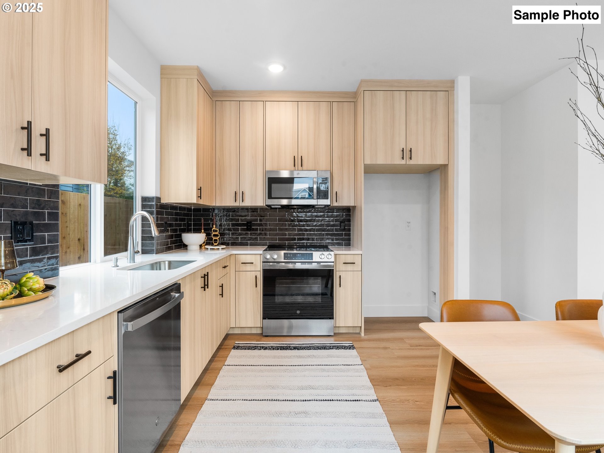 3554 North Haight Avenue, Unit 3 Portland, OR 97227 - Photo 8 of 20 a kitchen with a stove and white cabinets