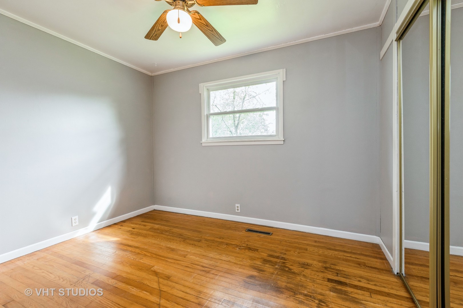 34 A Robin Road Carpentersville, IL 60110 - Photo 7 of 10 a view of an empty room with wooden floor and a window