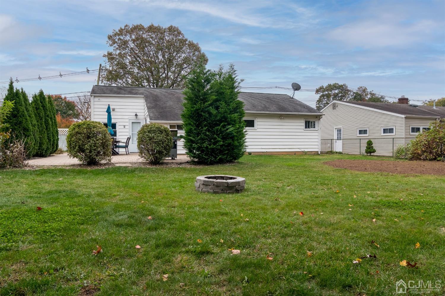 154 Winthrop Road Edison, NJ 08817 - Photo 16 of 18 a front view of a house with a garden and yard