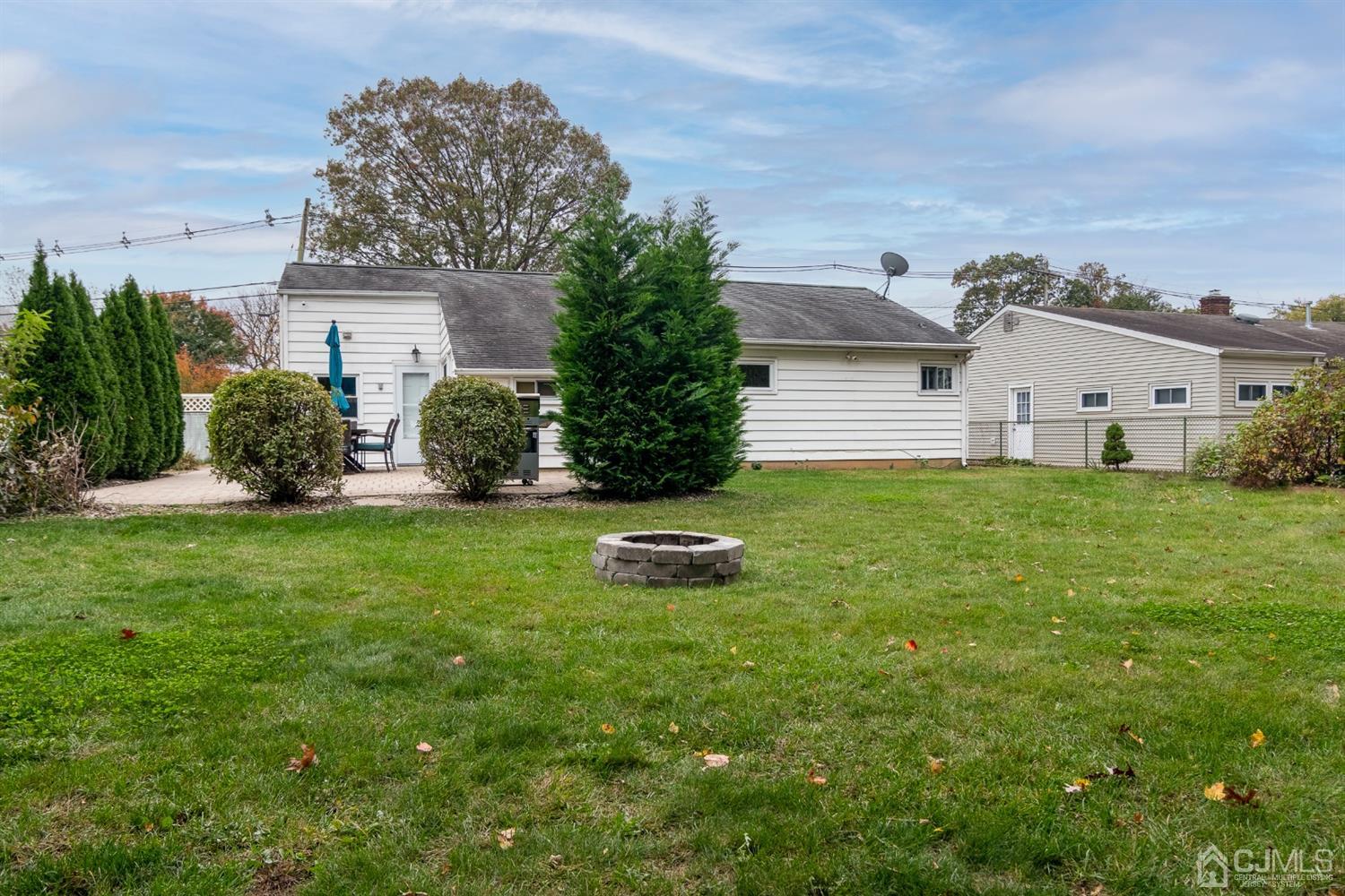 154 Winthrop Road Edison, NJ 08817 - Photo 17 of 18 a front view of a house with a garden and yard