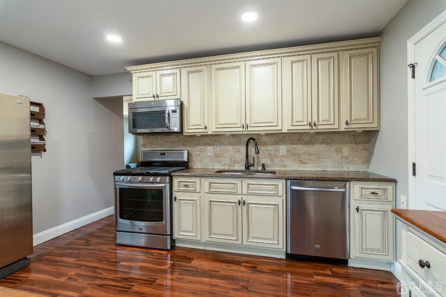 154 Winthrop Road Edison, NJ 08817 - Photo 6 of 18 a kitchen with stainless steel appliances granite countertop a stove a sink and a microwave