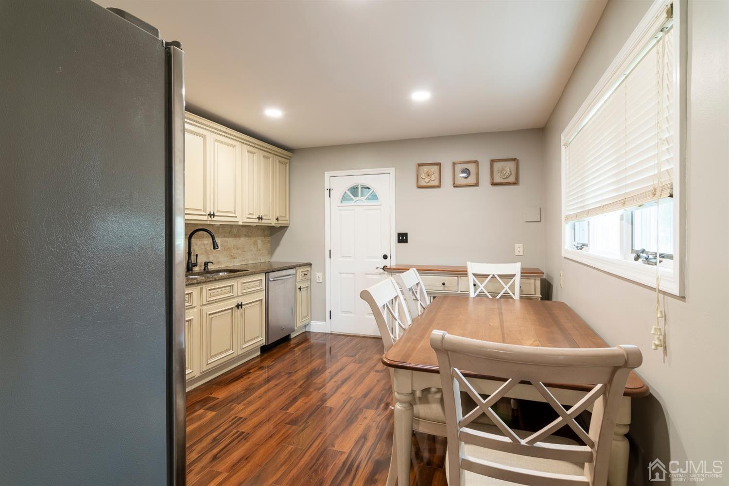 154 Winthrop Road Edison, NJ 08817 - Photo 8 of 18 a kitchen with a table chairs stove and cabinets