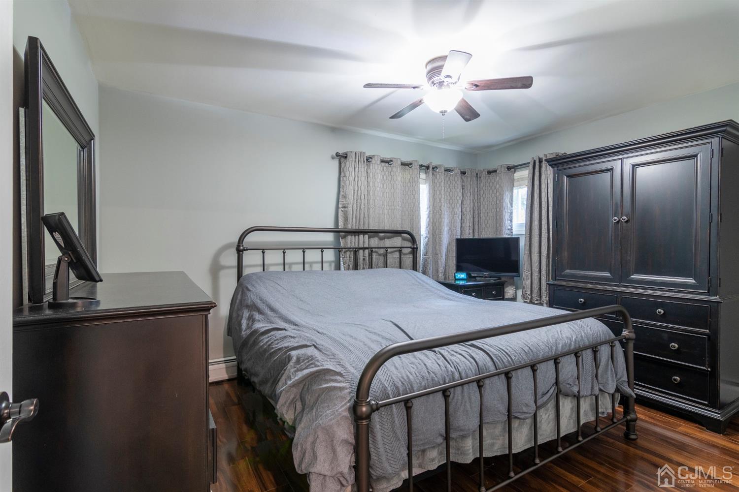 154 Winthrop Road Edison, NJ 08817 - Photo 10 of 18 a bedroom with a bed and a chandelier