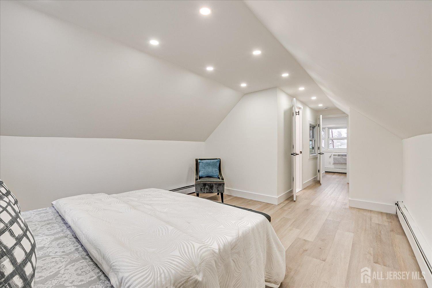 127 Tunison Road New Brunswick, NJ 08901 - Photo 8 of 12 a bedroom with a bed and a view of kitchen