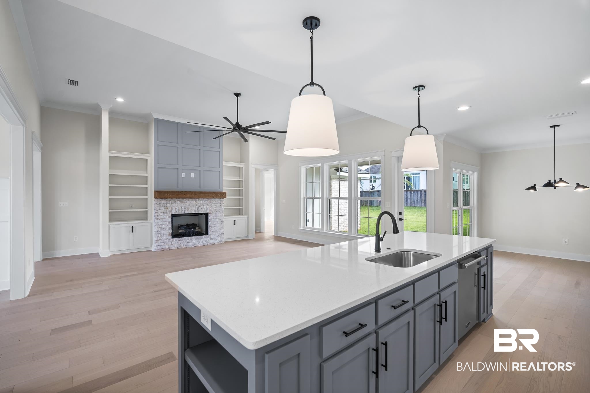 21826 Veranda Boulevard Fairhope, AL 36532 - Photo 11 of 42 Kitchen with gray cabinets, light wood-type flooring, decorative light fixtures, ornamental molding, and recessed lighting