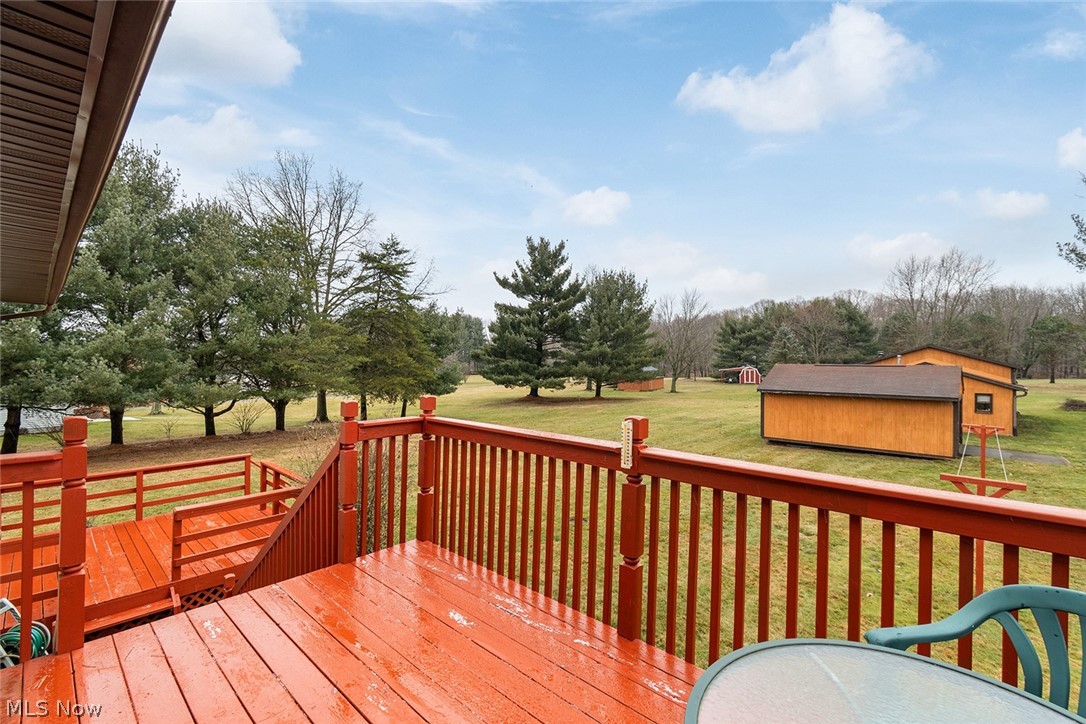 12640 Doylestown Road Rittman, OH 44270 - Photo 10 of 35 Wooden deck with an outdoor structure and a lawn