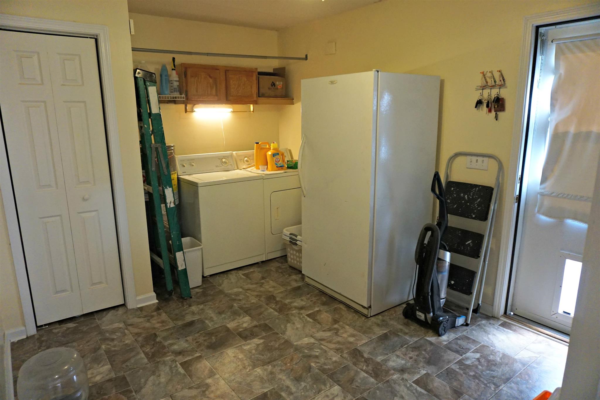 106 Walter Bartlett Road Manchester, TN 37355 - Photo 13 of 26 a view of a refrigerator in kitchen and an empty room with wooden floor