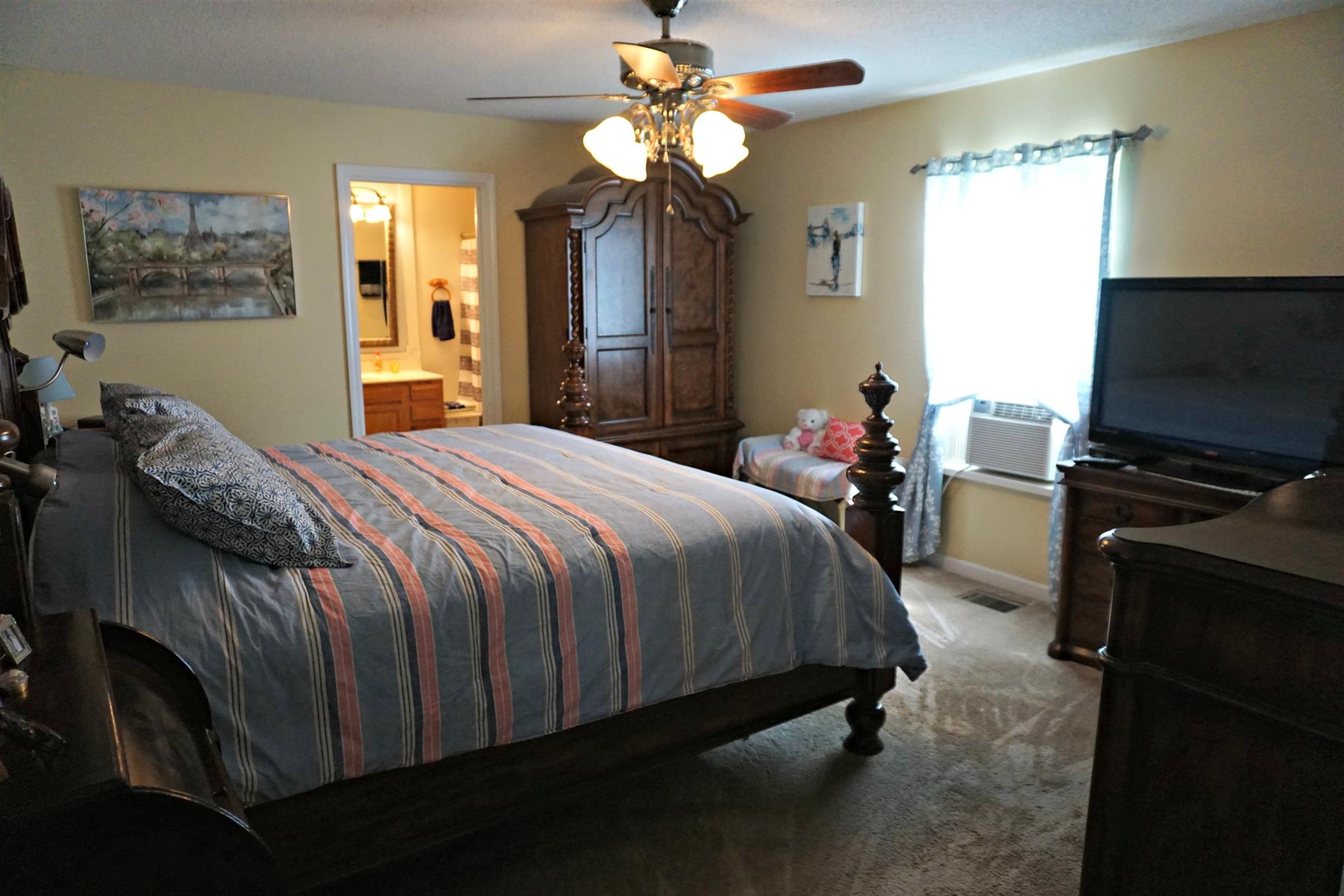 106 Walter Bartlett Road Manchester, TN 37355 - Photo 16 of 26 a bedroom with a bed and a flat tv screen on the dresser