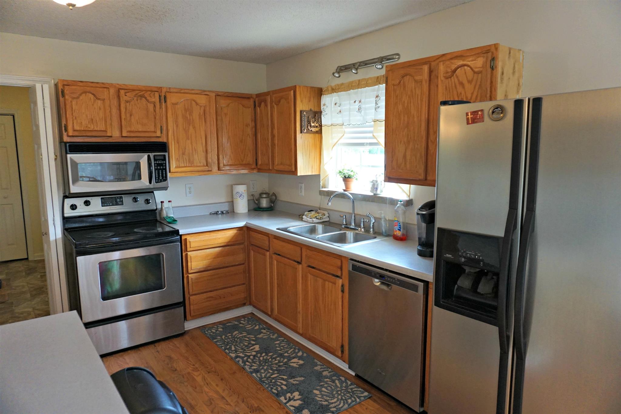 106 Walter Bartlett Road Manchester, TN 37355 - Photo 10 of 26 a kitchen with stainless steel appliances granite countertop a refrigerator sink and stove