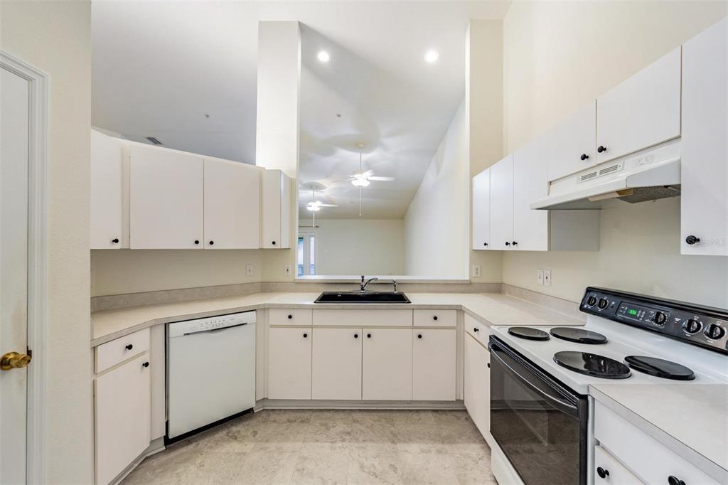 8406 Terrace Meadows Court Temple Terrace, FL 33637 - Photo 12 of 39 a kitchen with white cabinets and appliances