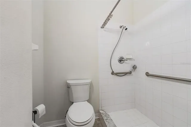 a bathroom with a toilet and a shower