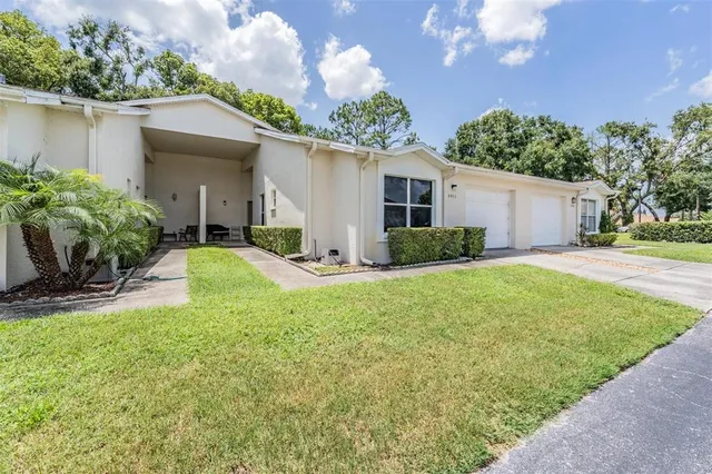 a view of a house with backyard and garden