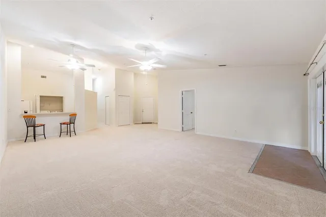 a view of a livingroom with furniture and a refrigerator