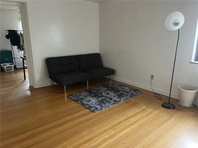 a view of a room with wooden floor and furniture