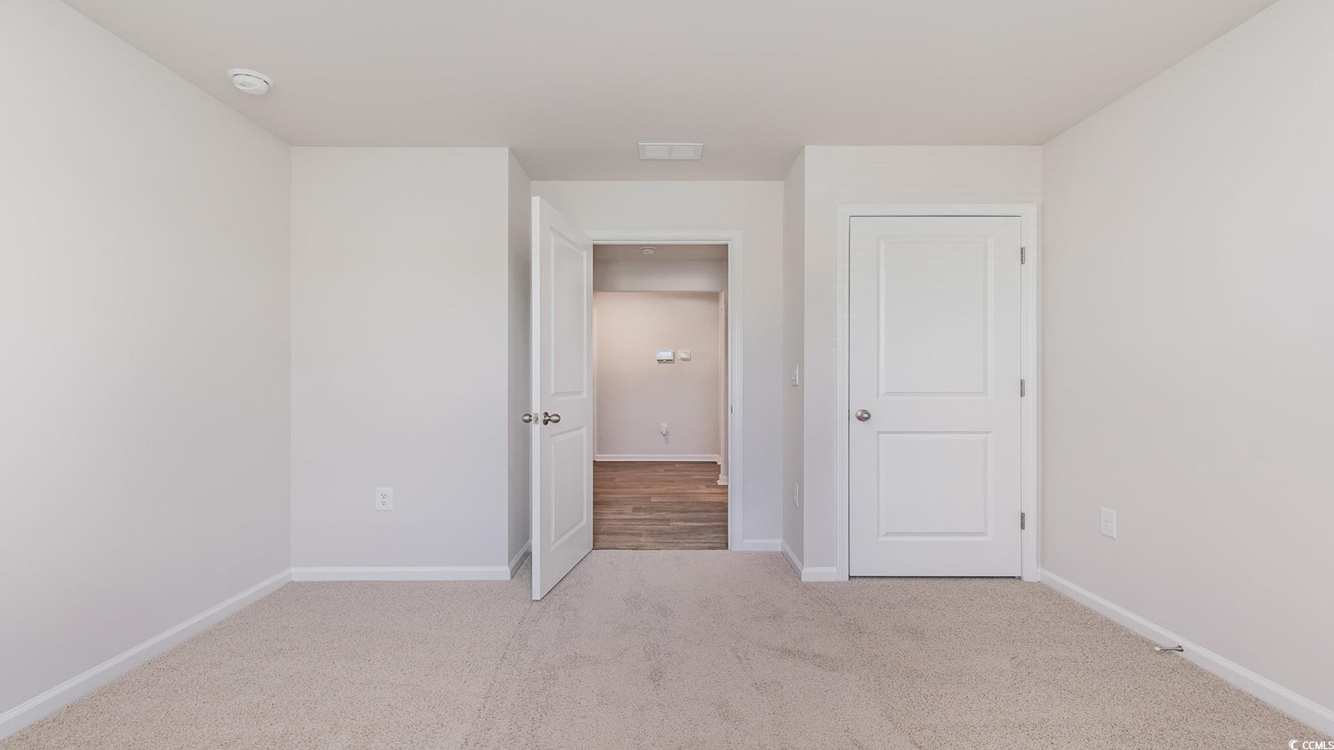 300 Long Beard Way Loris, SC 29569 - Photo 29 of 40 Unfurnished bedroom featuring light carpet and baseboards