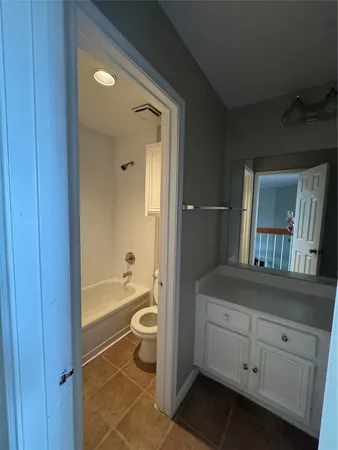 a bathroom with a toilet a sink and bathtub