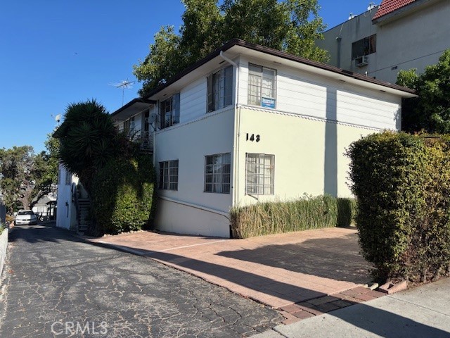 143 North Commonwealth Avenue Los Angeles, CA 90004 - Photo 1 of 2 a front view of a house with garden