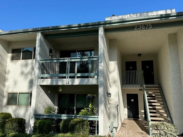 a front view of a house with plants