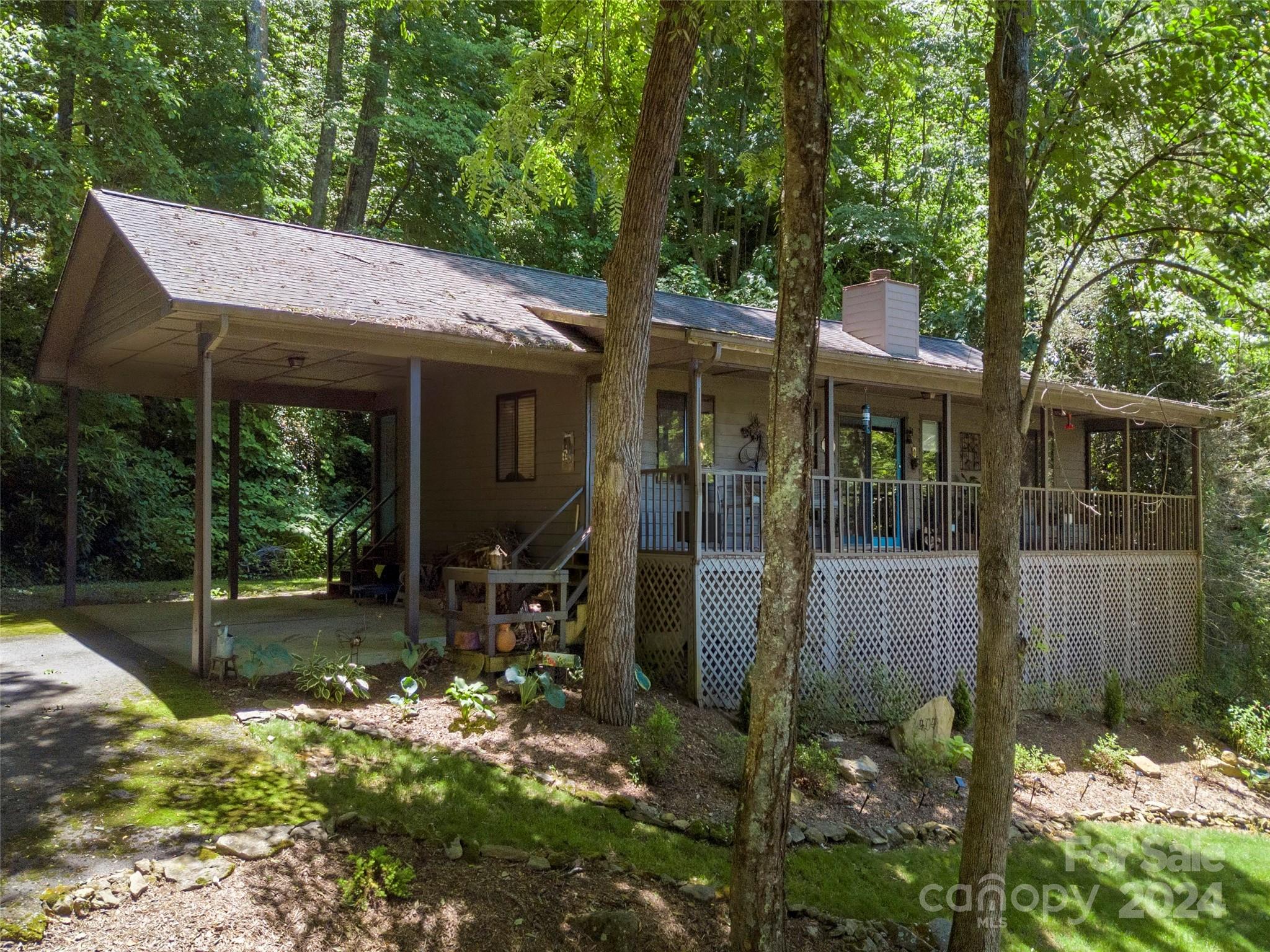 404 Old Country Road Waynesville, NC 28786 - Photo 20 of 22 a view of a patio with table and chairs under an umbrella