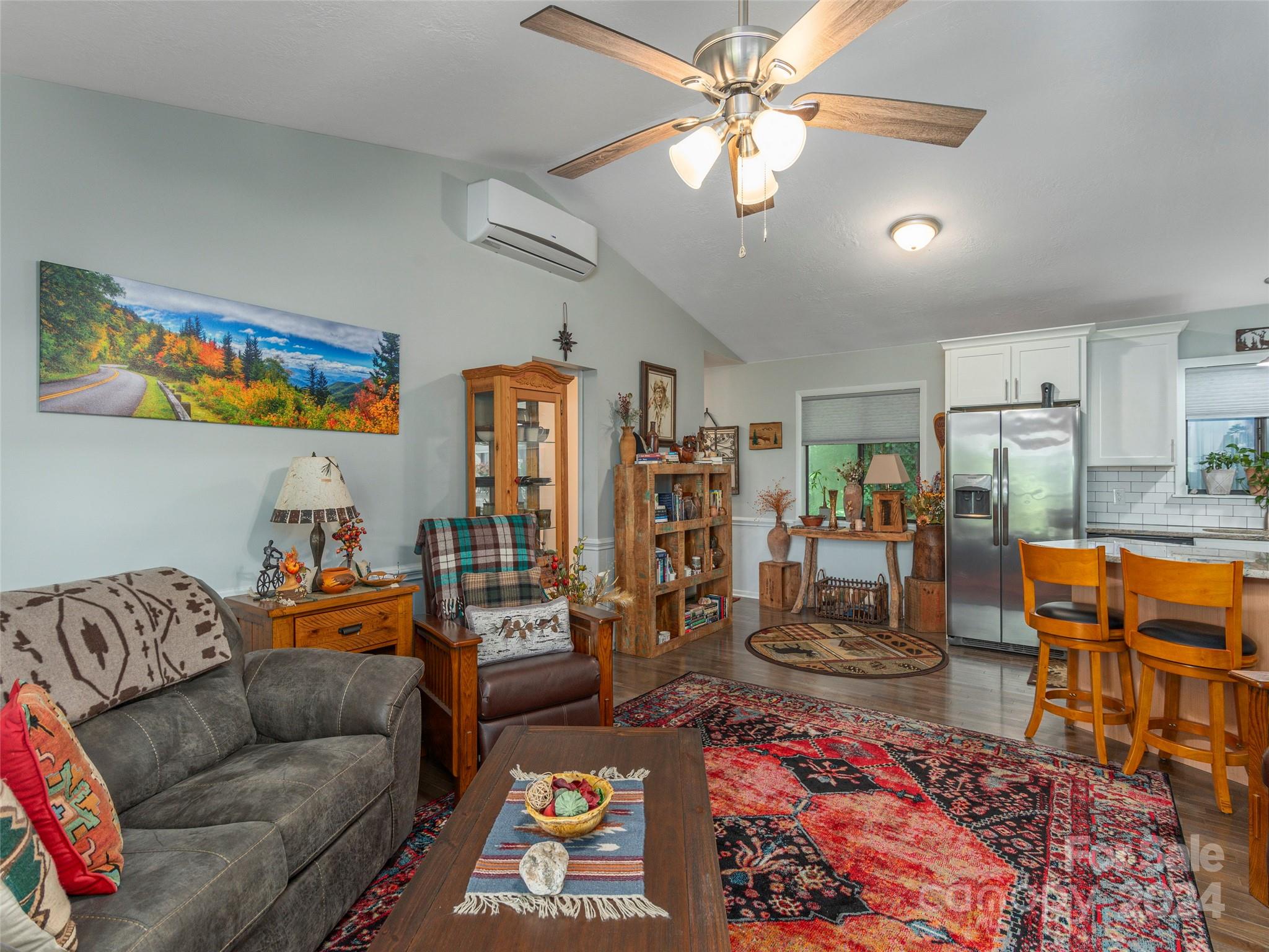 404 Old Country Road Waynesville, NC 28786 - Photo 8 of 22 a living room with furniture kitchen view and a chandelier