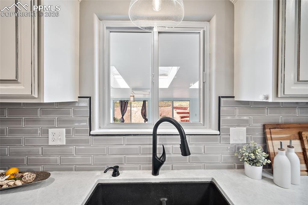 2304 Lazy R Lane Colorado Springs, CO 80915 - Photo 17 of 49 a kitchen with a sink and a window