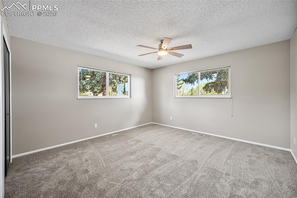 2304 Lazy R Lane Colorado Springs, CO 80915 - Photo 24 of 49 an empty room with windows and fan
