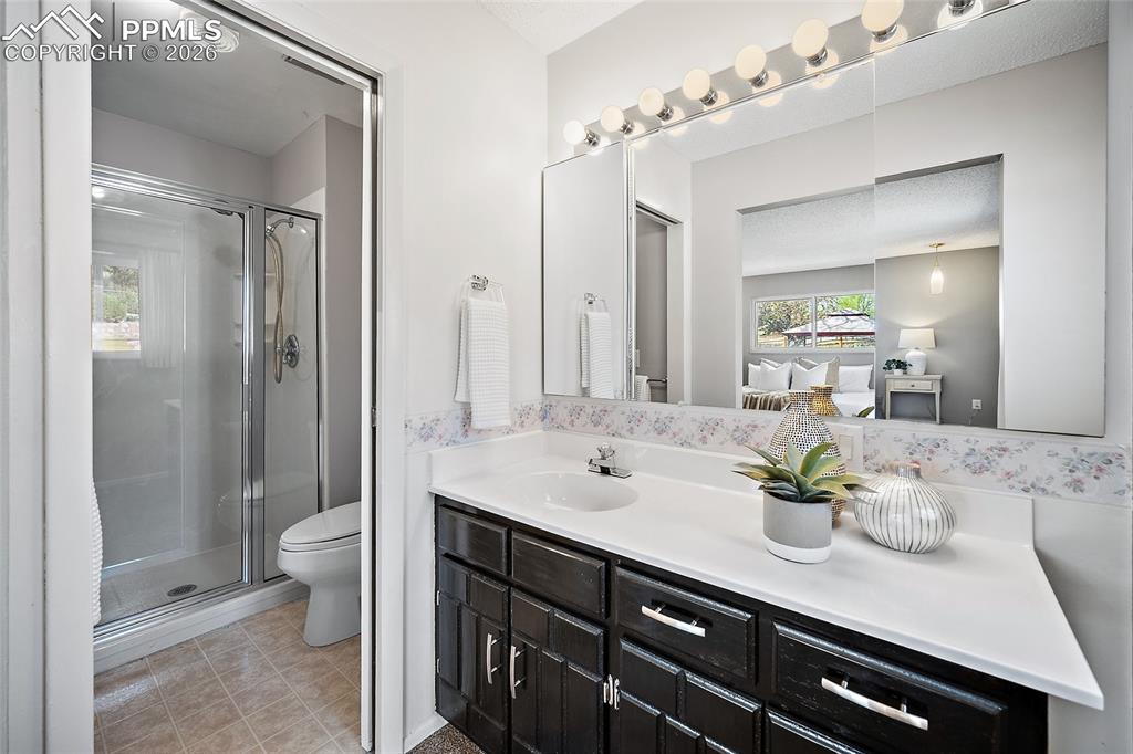 2304 Lazy R Lane Colorado Springs, CO 80915 - Photo 29 of 49 a bathroom with a sink a toilet and shower