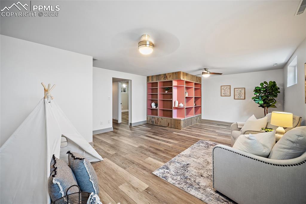 2304 Lazy R Lane Colorado Springs, CO 80915 - Photo 31 of 49 a living room with furniture and wooden floor