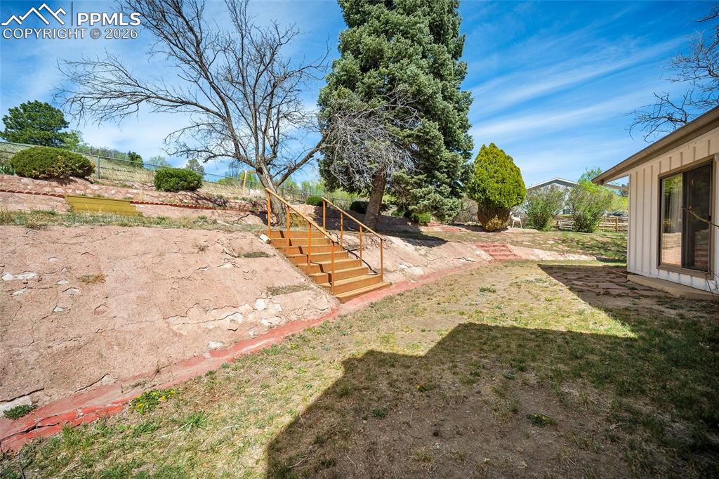 2304 Lazy R Lane Colorado Springs, CO 80915 - Photo 37 of 49 a view of a yard with plants and trees