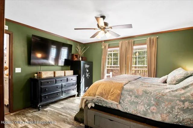 a bedroom with a bed next to a window