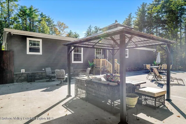 a swimming pool with outdoor seating and yard