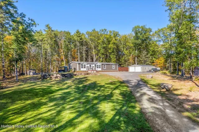a view of a house with swimming pool and lawn chairs