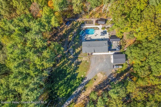 an aerial view of a house with a yard