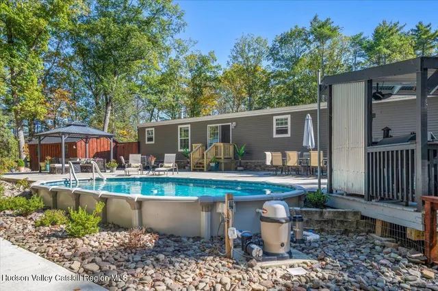 a view of a house with backyard sitting area and garden