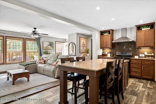 a living room with furniture a fireplace and a flat screen tv