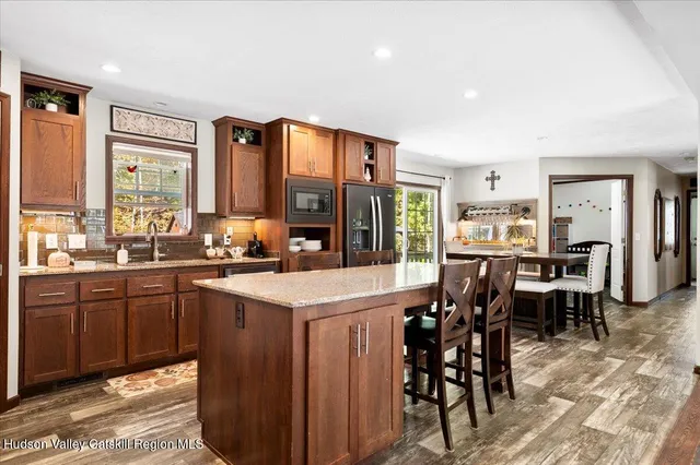 a living room with kitchen island furniture and a large window