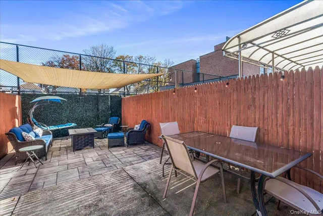 a backyard of a house with table and chairs