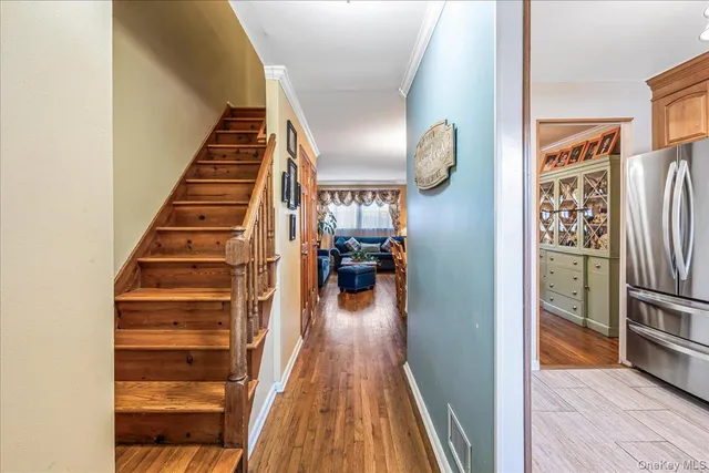 a view of entryway and hall with wooden floor
