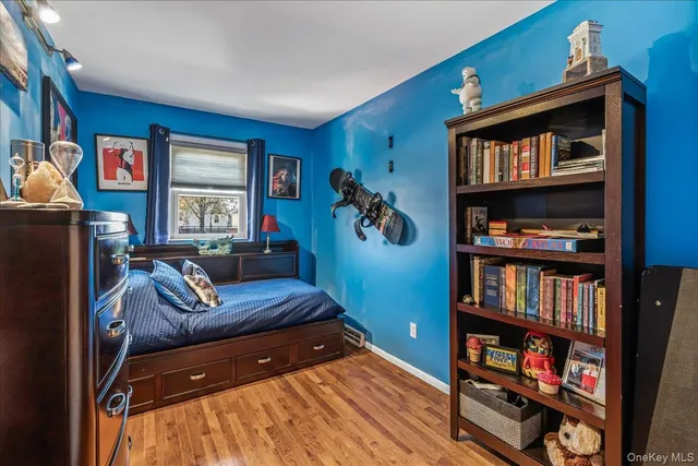 a living room with furniture and a book shelf