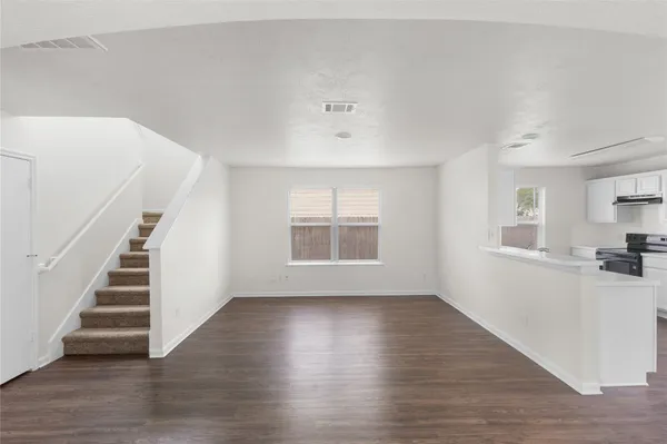 a view of wooden floor and windows in a room