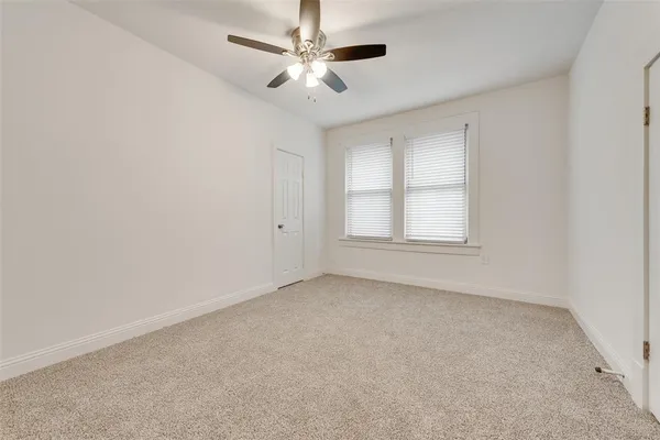 a spacious bedroom with a bed and a chandelier