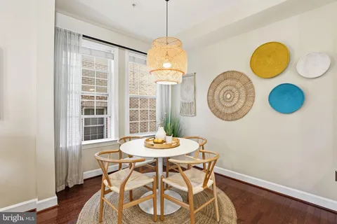 a dining room with furniture a window and kitchen view
