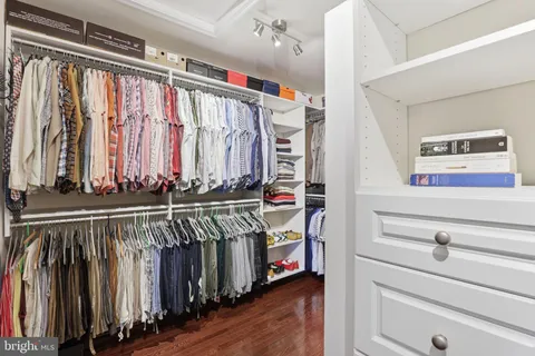 a bathroom with a granite countertop tub double vanity sink and large mirror