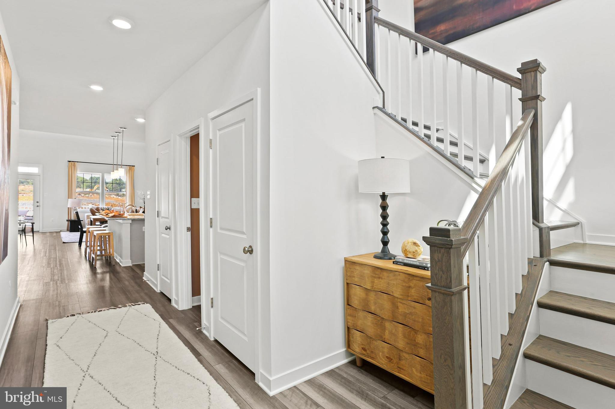 414 Silver Birch Drive Ranson, WV 25438 - Photo 3 of 15 a view of a hallway with wooden floor and staircase