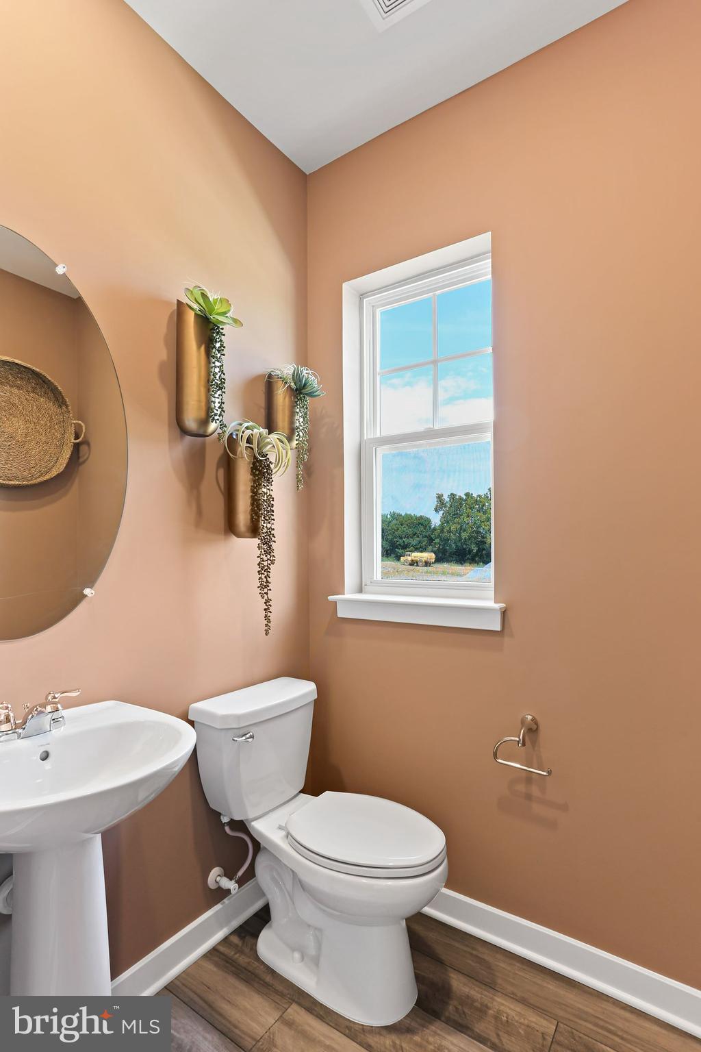 414 Silver Birch Drive Ranson, WV 25438 - Photo 8 of 15 a white toilet sitting next to a bathroom sink