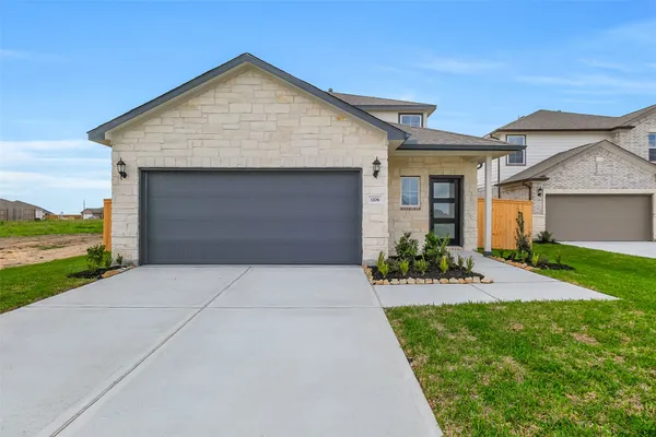 a front view of house with a yard and garage