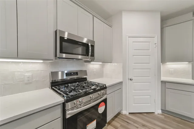 a kitchen with a stove and a microwave