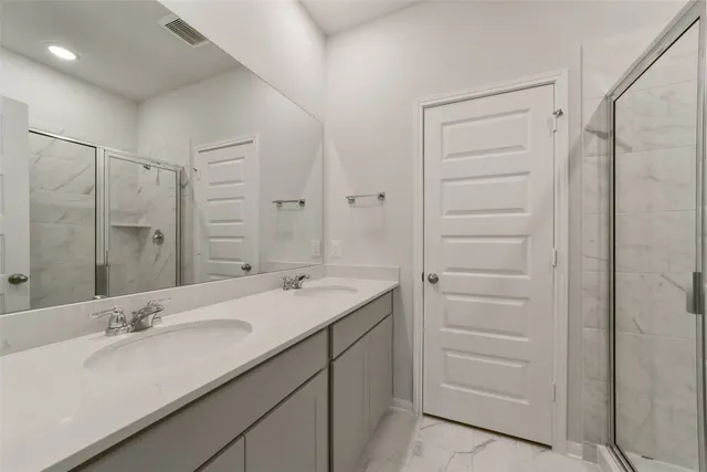 a bathroom with a double vanity sink mirror and double